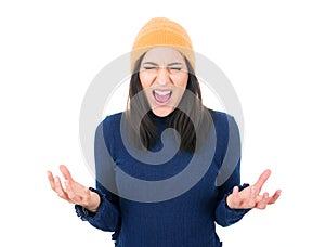 Furious girl looking at camera and shows fist, isolated on white background. Rage young woman