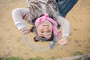 Furious little girl trying escape of father hands