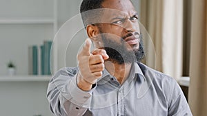 Furious mad angry aggressive bearded African American businessman in office close up professional manager employer man