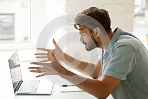 Furious man angry about bad news online or computer crash photo