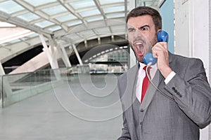 Furious man calling by old school payphone