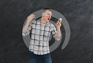 Furious man shouting at his mobile phone