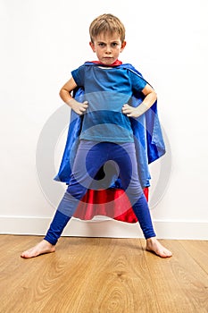 Furious superhero child standing, claiming empowerment with strong body language