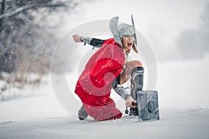 Furious woman in image of Germanic-Scandinavian God of thunder and storm. Cosplay.