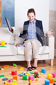 Furious woman in a room full of kids toys photo