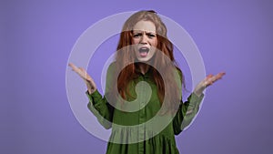 Furious woman on violet background. Lady in stress and rage, she threatens with aggression and looking at camera.