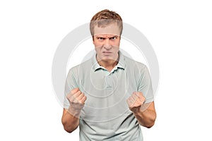 Furious young man in mint T-shirt ready to fight with fists isolated on white background photo