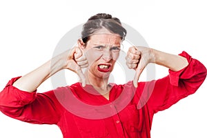 Furious young woman with disappointed thumbs down grinding teeth photo