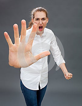 Furious young woman for self-defense, anger or rebellion photo