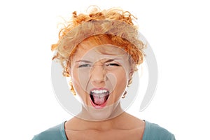 Furiouse young redhead woman screaming.