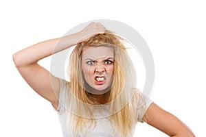 Furiously mad angry blonde woman holding hair
