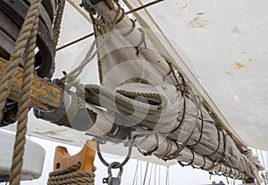 Furled sail on a boom on a tall ship