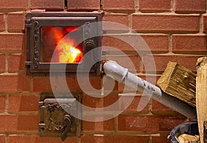 Furnace fire with firewood from refractory bricks in a village house