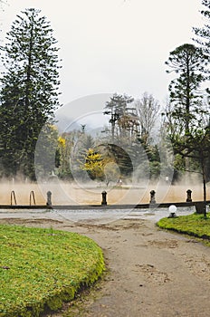 Furnas, Azores, Portugal - Jan 13, 2020: Hot spring iron water thermal pool in Terra Nostra Garden. The pool is surrounded by