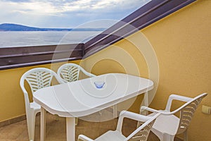 Furnished yellow balcony with wonderful view of Novi Vinodolski Croatia