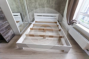 The furniture assembler assembles the bed frame, do it yourself and assemble new furniture