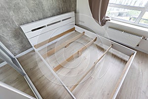 The furniture assembler assembles the bed frame, do it yourself and assemble new furniture