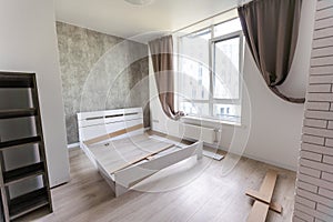 The furniture assembler assembles the bed frame, do it yourself and assemble new furniture