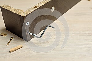 Furniture assembly using a tools, cordless screwdriver, clips and clamps close up