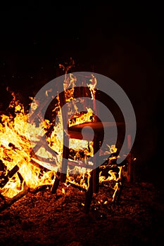 Furniture chair burning in a bonfire at night surreal fire elements