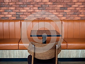 Furniture decoration in cafe retro style. Empty wood table bar and orange long leather sofa