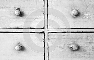 Furniture detail shot of vintage old white wooden chest of drawers background texture