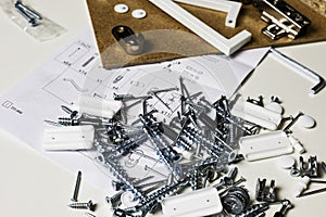 Furniture fittings. Furniture assembly hardware options and tools on a white background.