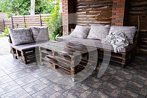 Furniture from pallets in the gazebo. Sofa and table in the barbecue lounge area
