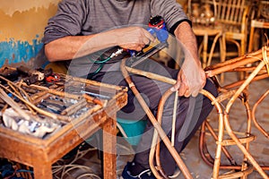 Furniture rattan chair and table decoration in process of manufacturing