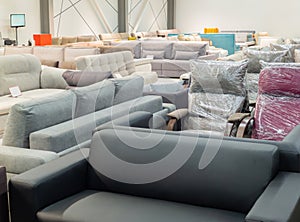 Furniture store with sofas and couches on display for sale, copy space. Shopping center with furniture department with sofas and