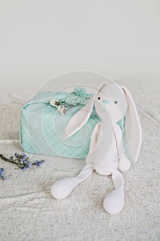 Furoshiki Japanese Gift fabric Wrapping and knitted toy rabbit. Zero waste, eco-friendly gift wrapping box. Fall hand
