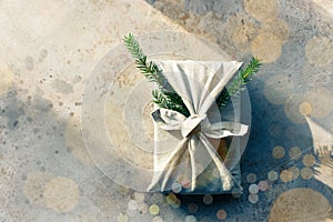 Furoshiki-style gift for Christmas or New Year on a white background with bokeh. Copy space.