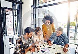 Furthering their reach through new markets. a team of designers having a meeting in an office.