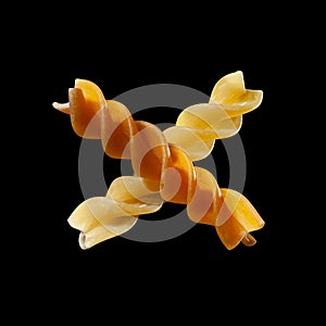 Fusilli, corkscrew-shaped pasta, Italian food, isolated on black background