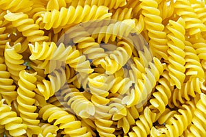 Fusilli helix shaped Macaroni Pasta raw food background or texture close up