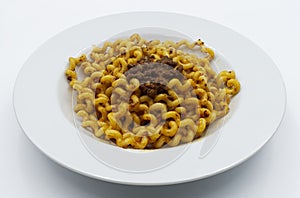 Fusilli Lunghi Bucati with bolognese sauce on a white plate isolated on white. Traditional italian pasta