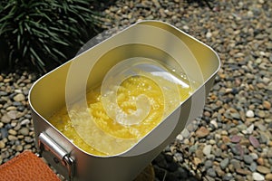 Fusilli pasta being boiled in a mess tin