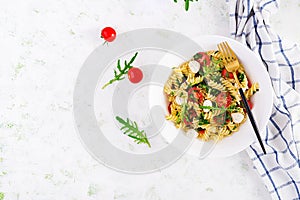 Fusilli Pasta - Caprese salad with tomato, mozzarella and basil. Top view, flat lay, copy space