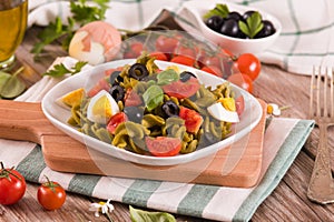 Fusilli pasta with cherry tomatoes, eggs and black olives.