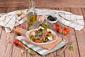 Fusilli pasta with cherry tomatoes, eggs and black olives.