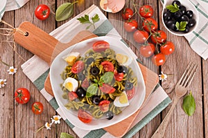 Fusilli pasta with cherry tomatoes, eggs and black olives.