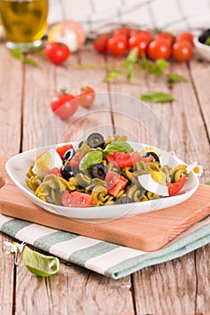 Fusilli pasta with cherry tomatoes, eggs and black olives.