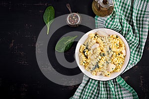 Fusilli pasta with a creamy sauce with chicken meat, parmesan cheese and spinach