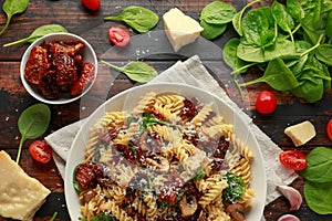 Fusilli Pasta with sun dried tomatoes, mushrooms, parmesan cheese and spinach. healthy food.