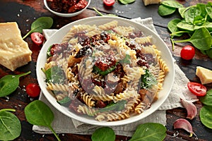 Fusilli Pasta with sun dried tomatoes, mushrooms, parmesan cheese and spinach. healthy food.