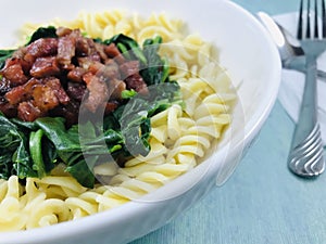 Fusion cuisine. BBQ pork and twisty pasta and vegetable.