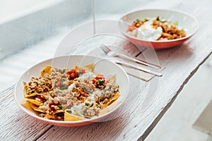 Fusion food Soboro Chicken Nachos: Japanese-style stir-fried chicken with tomato salsa, yogurt and Thai-style seafood sauce