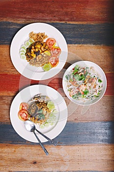 Fusion Thai Meal: Top view of Fried rice Mackerel Paste with Thai Mackerel, Thai Pineapple Fried Rice and Spicy rice vermicelli wi