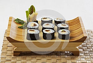 Futomaki on wooden tray. Japanese restaurant food.