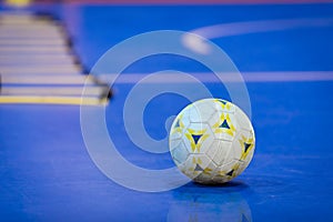 Futsal Ball on Blue Indoor Field. Blue Futsal Training Pitch.